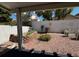 View of a gravel backyard including an outdoor seating area for dining al fresco at 2419 Pebble Springs Ct, Henderson, NV 89074