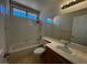 Bright bathroom with tiled shower and tub, updated vanity with sink, and a well-lit mirror at 2419 Pebble Springs Ct, Henderson, NV 89074