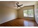 This spacious bedroom features hardwood floors, vaulted ceilings, a ceiling fan, and lots of natural light at 2419 Pebble Springs Ct, Henderson, NV 89074