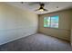 Bedroom with neutral walls, carpeting, a ceiling fan, and one window overlooking a serene view at 2419 Pebble Springs Ct, Henderson, NV 89074