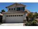 Two-story home featuring a tile roof, two car garage, stucco siding, and well-manicured front yard at 2419 Pebble Springs Ct, Henderson, NV 89074