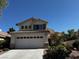 Charming home featuring a two-car garage, tile roof, and desert landscaping at 2419 Pebble Springs Ct, Henderson, NV 89074