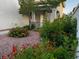 The house has some decorative plants to the right of the entryway, with a red rock mulch covering the landscaped area at 2419 Pebble Springs Ct, Henderson, NV 89074