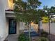 Inviting front porch with decorative stone columns, a small tree, and fresh landscaping enhance the curb appeal at 2419 Pebble Springs Ct, Henderson, NV 89074