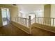 Upstairs hallway with carpet flooring and decorative white railing overlooking downstairs at 2419 Pebble Springs Ct, Henderson, NV 89074
