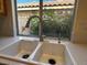 Kitchen sink features stainless steel faucet and double basin with a view of the landscape at 2419 Pebble Springs Ct, Henderson, NV 89074