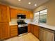 Kitchen featuring wood cabinets, stainless steel appliances, and a kitchen window overlooking outdoors at 2419 Pebble Springs Ct, Henderson, NV 89074