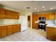 Spacious kitchen featuring tiled floors, wood cabinets, and modern stainless steel appliances at 2419 Pebble Springs Ct, Henderson, NV 89074