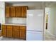 Kitchen features wood cabinets and drawers with a white refrigerator at 2419 Pebble Springs Ct, Henderson, NV 89074