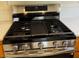 Close-up view of a stainless steel gas range at 2419 Pebble Springs Ct, Henderson, NV 89074