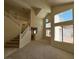 Bright living area with high ceilings, large windows, and a staircase at 2419 Pebble Springs Ct, Henderson, NV 89074