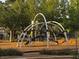 Modern playground with climbing structures and a soft landing surface for , nestled among mature trees at 2419 Pebble Springs Ct, Henderson, NV 89074