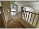 A carpeted staircase with white railing leads to the upper level of the home at 2419 Pebble Springs Ct, Henderson, NV 89074