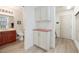 Bright bathroom featuring wood cabinets, neutral tones, and a view into the storage and utility area at 2420 Desert Butte Dr, Las Vegas, NV 89134