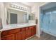 Bathroom featuring a double vanity with wood cabinets and a glass-enclosed shower at 2420 Desert Butte Dr, Las Vegas, NV 89134