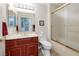 Bathroom featuring a wood cabinet, marble countertop, framed mirror, and a shower with a frosted glass enclosure at 2420 Desert Butte Dr, Las Vegas, NV 89134