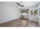 Bedroom with built-in desk and shelving, a ceiling fan, and wood-look flooring at 2420 Desert Butte Dr, Las Vegas, NV 89134