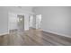 Clean and simple bedroom showcasing a mirrored closet and wood-look floors at 2420 Desert Butte Dr, Las Vegas, NV 89134