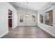 Bright dining room with modern chandelier, high ceiling, wood-look floors, and lots of natural light at 2420 Desert Butte Dr, Las Vegas, NV 89134