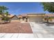 Single story home featuring a two car garage, desert landscaping and a tile roof at 2420 Desert Butte Dr, Las Vegas, NV 89134