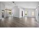Open-concept living room featuring vaulted ceilings, modern light fixtures and hardwood flooring at 2420 Desert Butte Dr, Las Vegas, NV 89134