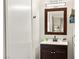 Bathroom featuring a modern vanity with dark wood cabinets, white countertop, and stylish mirror at 2569 Paradise Village Way, Las Vegas, NV 89120