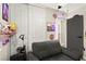 Bedroom featuring a comfortable sofa, closet storage, and creative decor at 2569 Paradise Village Way, Las Vegas, NV 89120
