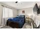 Bedroom with a cozy bed, a ceiling fan, and a mounted TV for relaxed viewing at 2569 Paradise Village Way, Las Vegas, NV 89120