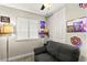 Bedroom with a window for natural light, a plush sofa, and tasteful decor at 2569 Paradise Village Way, Las Vegas, NV 89120