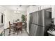 A dining area that shows a stainless steel refrigerator and wooden table with chairs at 2569 Paradise Village Way, Las Vegas, NV 89120