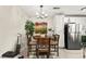 A charming dining area featuring a round wooden table with decor, and natural lighting at 2569 Paradise Village Way, Las Vegas, NV 89120