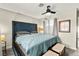 Comfortable bedroom with a plush, large headboard bed and ceiling fan at 2569 Paradise Village Way, Las Vegas, NV 89120