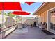 Stylish patio area features an outdoor dining set, cushioned seating, decorative wall accents, and a wood deck at 2569 Paradise Village Way, Las Vegas, NV 89120