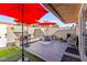 Inviting outdoor patio with artificial grass, red umbrellas, and comfortable seating for relaxing and entertaining at 2569 Paradise Village Way, Las Vegas, NV 89120