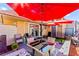 Outdoor patio with comfortable seating, shade umbrellas, access to the house through glass doors and outdoor space at 2569 Paradise Village Way, Las Vegas, NV 89120