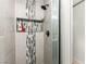 Close-up of shower showcasing stylish tilework, a recessed shelf, and modern fixtures at 2569 Paradise Village Way, Las Vegas, NV 89120