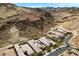 Expansive aerial view of upscale homes with desert landscaping, built against a dramatic mountain backdrop at 26 Costa Tropical Dr, Henderson, NV 89011