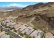 Stunning aerial view of luxury homes, some with solar panels, nestled against mountains, offering serene living at 26 Costa Tropical Dr, Henderson, NV 89011
