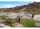 An aerial view showcasing desert home with solar panels against a mountain backdrop at 26 Costa Tropical Dr, Henderson, NV 89011