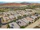 High angle aerial view displays homes with solar panels near a lake and a golf course, offering luxurious community living at 26 Costa Tropical Dr, Henderson, NV 89011