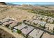 Scenic aerial shot featuring a pool, modern homes with solar panels, and a mountain backdrop at 26 Costa Tropical Dr, Henderson, NV 89011
