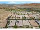Wide aerial perspective showcasing a residential community with a lake and golf course in the background at 26 Costa Tropical Dr, Henderson, NV 89011