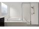 Clean bathroom featuring a large soaking tub and glass-enclosed shower at 26 Costa Tropical Dr, Henderson, NV 89011