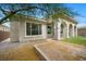 Inviting home exterior with arched entry, manicured lawn, and charming landscaping at 26 Costa Tropical Dr, Henderson, NV 89011