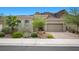 Inviting single-story home with desert landscaping and attached two car garage at 26 Costa Tropical Dr, Henderson, NV 89011