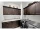 Well-organized laundry room with modern washer and dryer, ample storage, and white countertops at 26 Costa Tropical Dr, Henderson, NV 89011