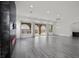 Bright, open living room featuring large windows, modern fireplace and easy access to other parts of the home at 26 Costa Tropical Dr, Henderson, NV 89011