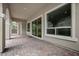 Covered outdoor patio with large windows, brick floor, and outdoor access at 26 Costa Tropical Dr, Henderson, NV 89011