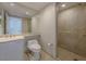Luxurious bathroom featuring a vanity, toilet, marble tile floors, and glass door shower at 2747 Paradise Rd # 2305, Las Vegas, NV 89109