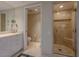 Modern bathroom featuring a glass shower, marble floors, white cabinets, and luxurious fixtures at 2747 Paradise Rd # 2305, Las Vegas, NV 89109